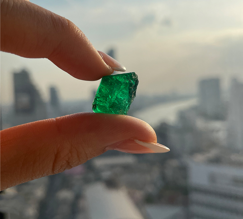 Emerald rough stone in the bangkok skyline